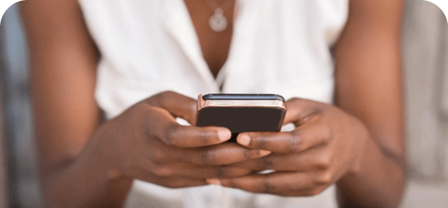 Closeup of female hands holding and texting on mobile phone